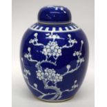 Large Chinese porcelain ginger jar and cover, the blue ground with prunus decoration