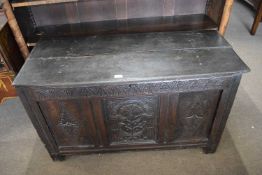 17th century and later oak coffer of plain board top and a front with three carved panels, 120cm