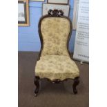 Victorian mahogany framed nursing chair with front cabriole legs and floral upholstery, 107cm high