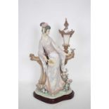 Large Lladro model of a geisha standing against a lamp, on a shaped wooden base, 40cm high