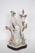 Large Lladro model of a geisha standing against a lamp, on a shaped wooden base, 40cm high