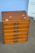 Small late 19th/early 20th century stained wooden six-drawer filing chest with metal handles, 43cm