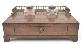 A walnut desk set with two glass inkwells and pen tray late 19th century
