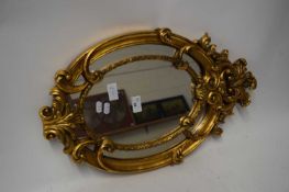 MODERN OVAL WALL MIRROR SET IN GILT FRAME