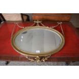 OVAL BEVELLED WALL MIRROR SET IN A FRAME WITH URN AND GARLAND MOUNTS, 70CM WIDE