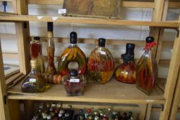 QUANTITY OF GLASS BOTTLES FILLED WITH OIL AND VARIOUS CHILLI PEPPERS AND LEGUMES