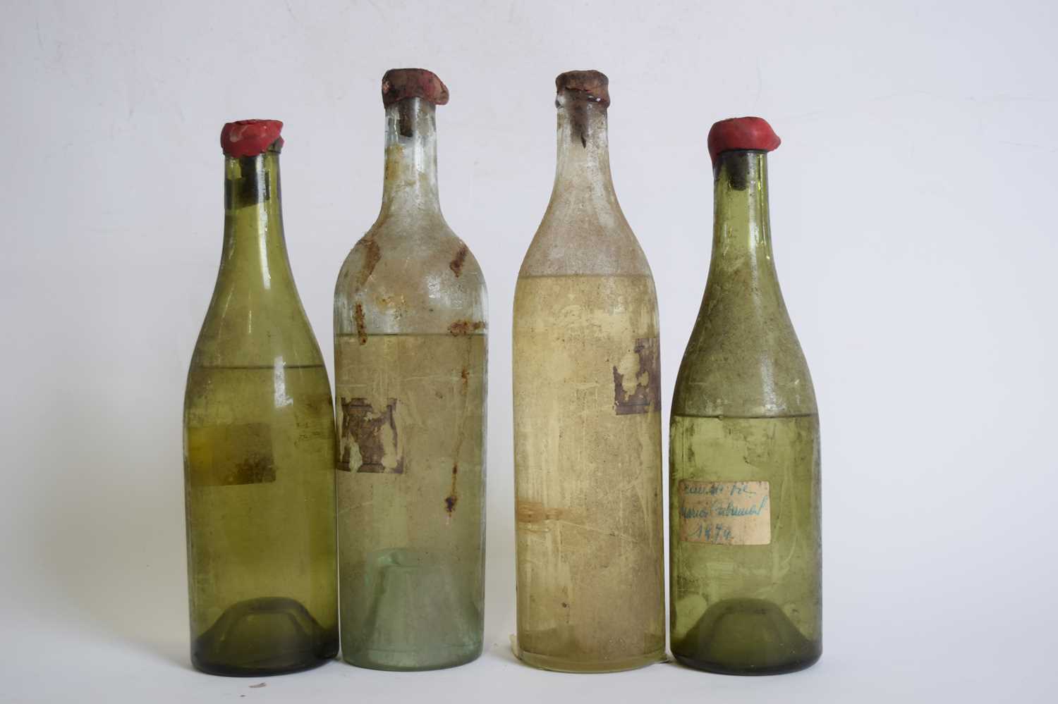 Four bottles of unlabelled unknown wine/spirits (levels vary)