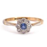 Sapphire and diamond cluster ring, the round cut sapphire within a small diamond surround, framed