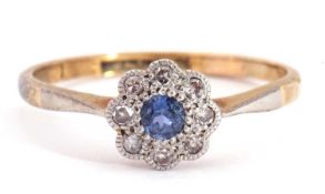 Sapphire and diamond cluster ring, the round cut sapphire within a small diamond surround, framed