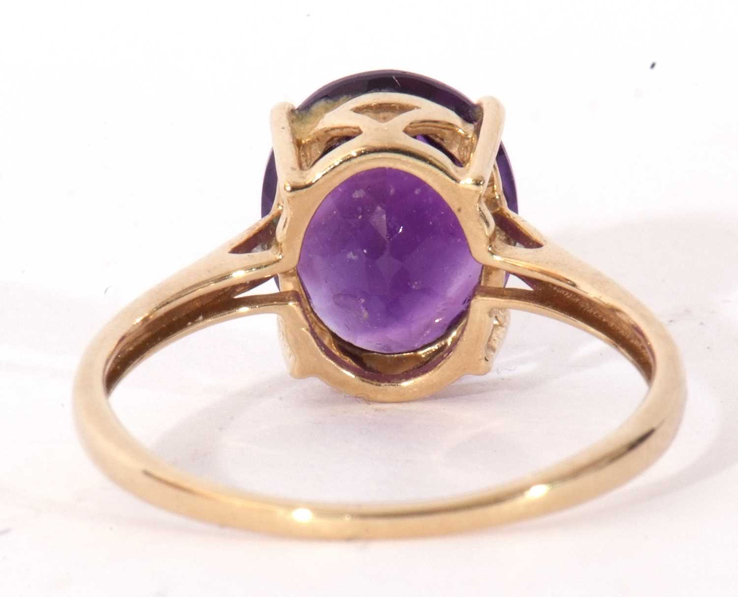 Modern 9ct gold amethyst and diamond ring, the oval faceted amethyst basket set and raised between - Image 5 of 9