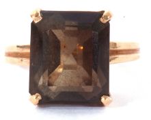 Smoky quartz dress ring, the step cut quartz 12 x 10mm, four claw set in a pierced basket yellow