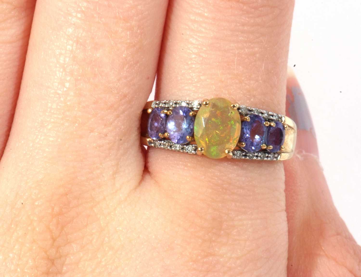 Modern 9ct gold, opal, tanzanite and diamond ring, the oval cut opal raised above a tanzanite and - Image 8 of 8