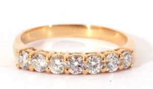 Seven stone diamond ring line set with seven round brilliant cut small diamonds, individually claw