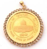 Kuwait 100 dinars gold coin, circa 1981, in an unmarked diamond surround pendant mount, coin