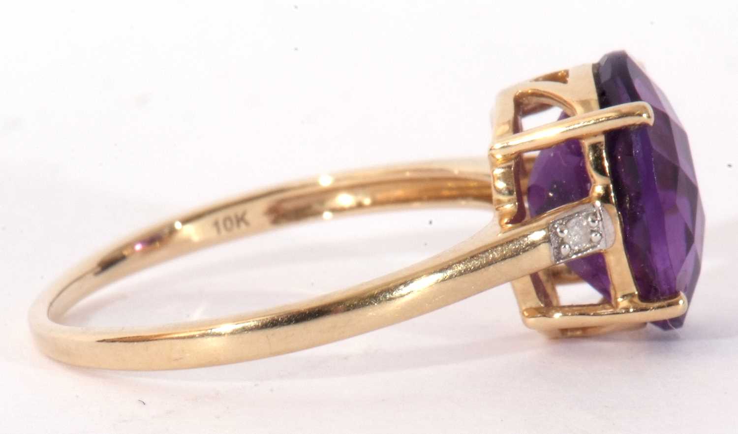 Modern 9ct gold amethyst and diamond ring, the oval faceted amethyst basket set and raised between - Image 7 of 9