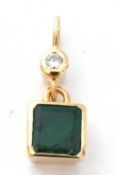 A high grade yellow metal emerald and diamond pendant, the flat square cut emerald framed and