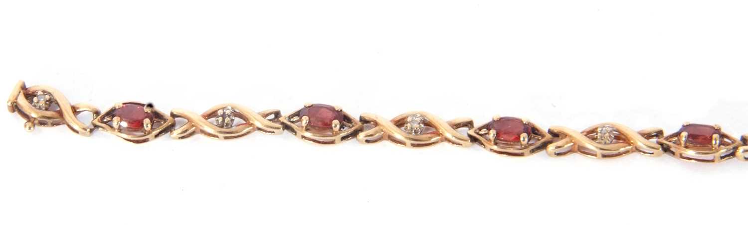 Modern 9ct gold and garnet small diamond line bracelet, alternate set with nine small oval cut - Image 6 of 6