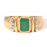 Modern green and white stone set ring featuring a central rectangular cut green stone in rub-over