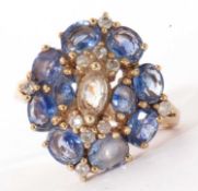 Modern 9k stamped cluster ring set throughout with blue and white paste stones and highlighted
