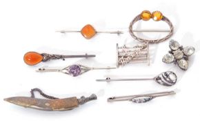 Mixed Lot: metal scimitar brooch, two white metal and carnelian stone set brooches, Scottish