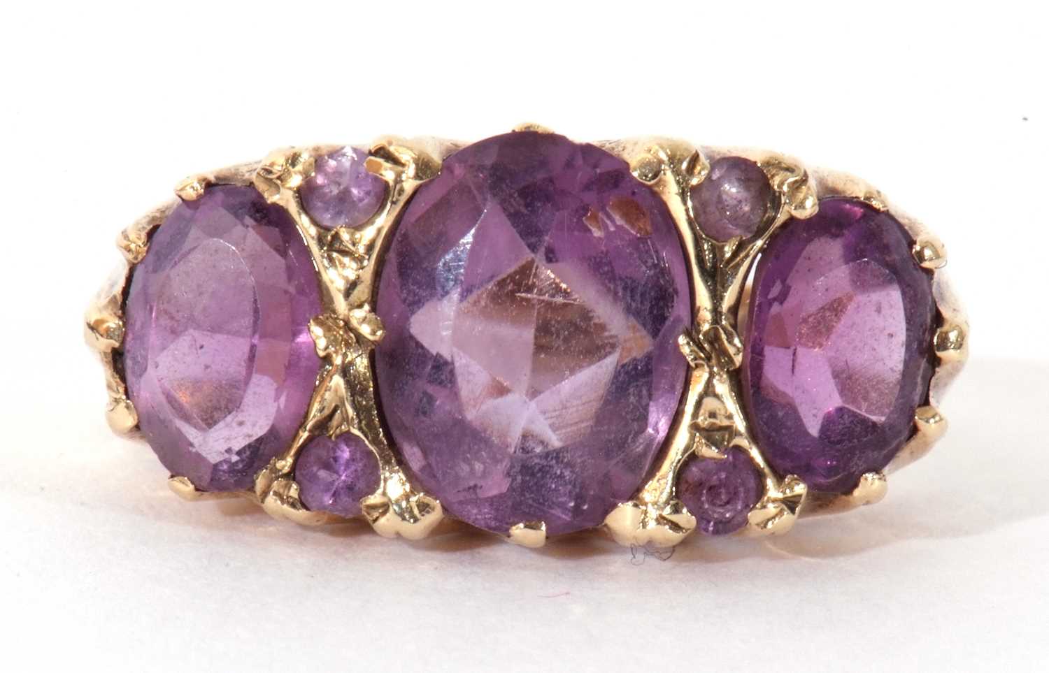 9ct gold three stone amethyst ring featuring three graduated oval facet cut amethysts highlighted