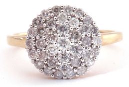 Modern 9ct gold and diamond cluster ring, the circular panel decorated all over with small single