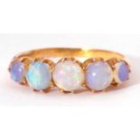 Five stone opal ring, line set with graduated round cabochon cut opals, set in a mid-grade yellow