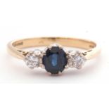 18ct gold sapphire and diamond three stone ring centring an oval faceted sapphire between two