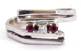 Precious metal stylised small ruby and diamond ring of angular design, highlighted with a small