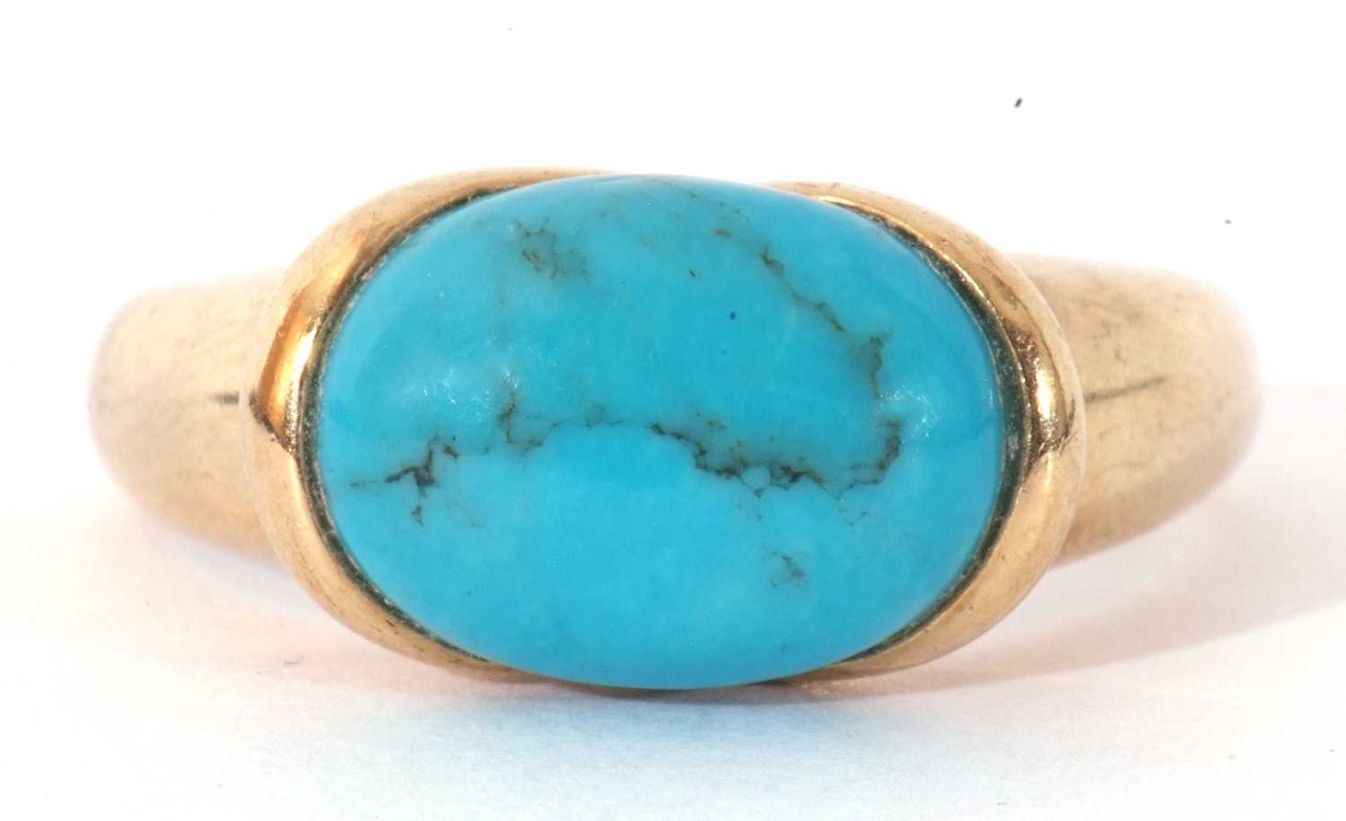 Modern 9ct gold turquoise set dress ring, the cabochon shaped turquoise in rub-over setting