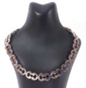 Heavy white metal collar necklace, a design featuring 'C' scroll articulated links to a hidden box