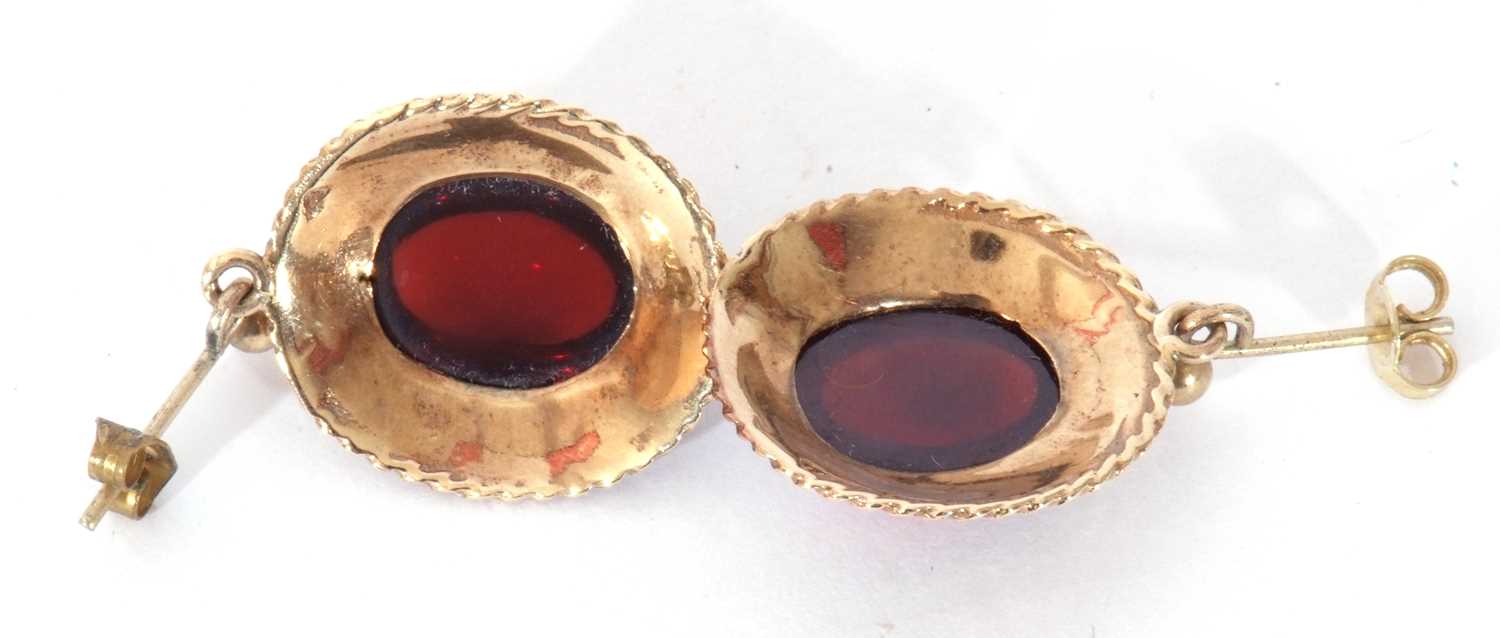 Pair of yellow metal and garnet set earrings, the oval cut cabochon centres in cut down settings and - Image 3 of 3