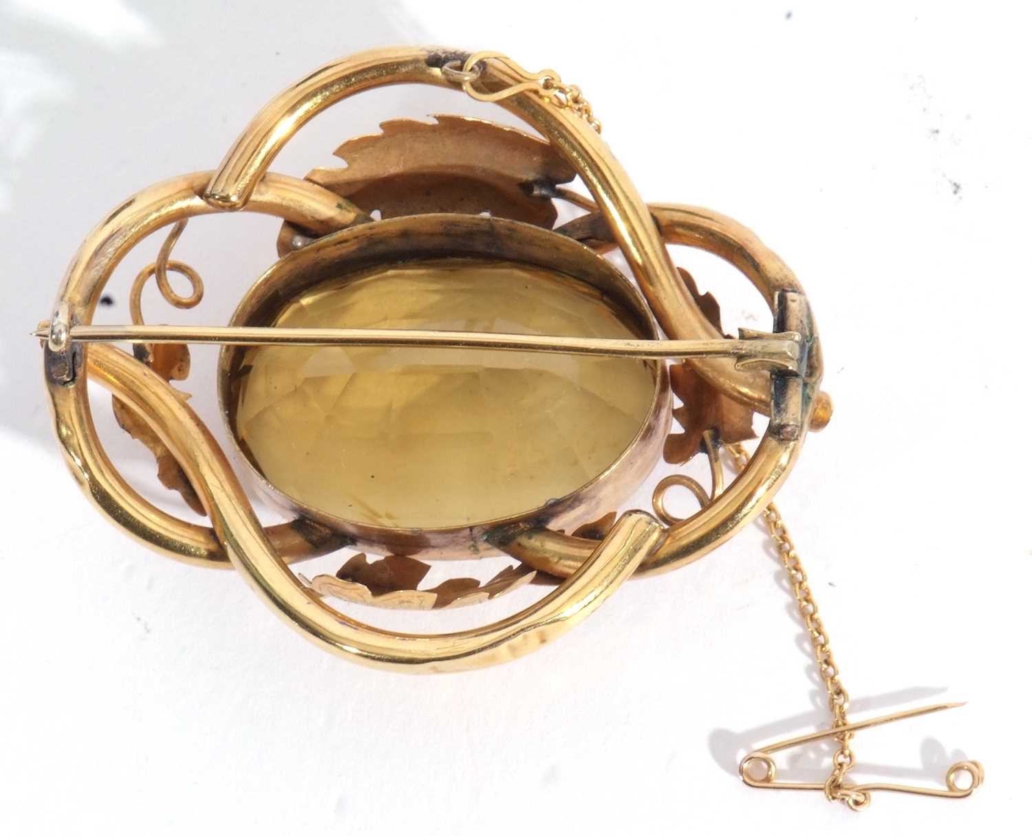 Antique gold and citrine brooch, the tubular and leaf decorated frame centring a large faceted lemon - Image 3 of 3
