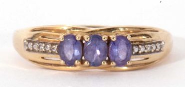 14ct stamped gold, blue stone and diamond ring, the centre with three oval faceted cut blue stones