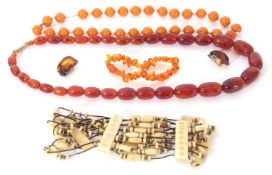 Mixed Lot: Cognac coloured amber graduated bead necklace, an amber fragment bead bracelet, pair of
