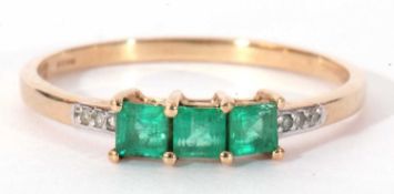 Modern 9ct gold, emerald and diamond ring, the three small square stepped cut emeralds raised