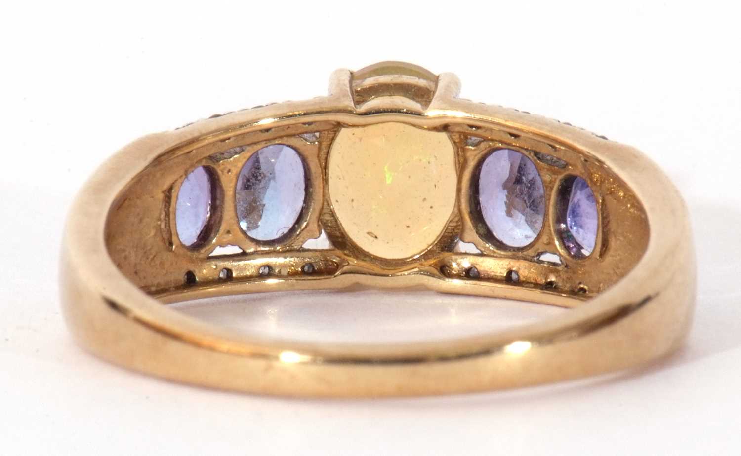 Modern 9ct gold, opal, tanzanite and diamond ring, the oval cut opal raised above a tanzanite and - Image 4 of 8