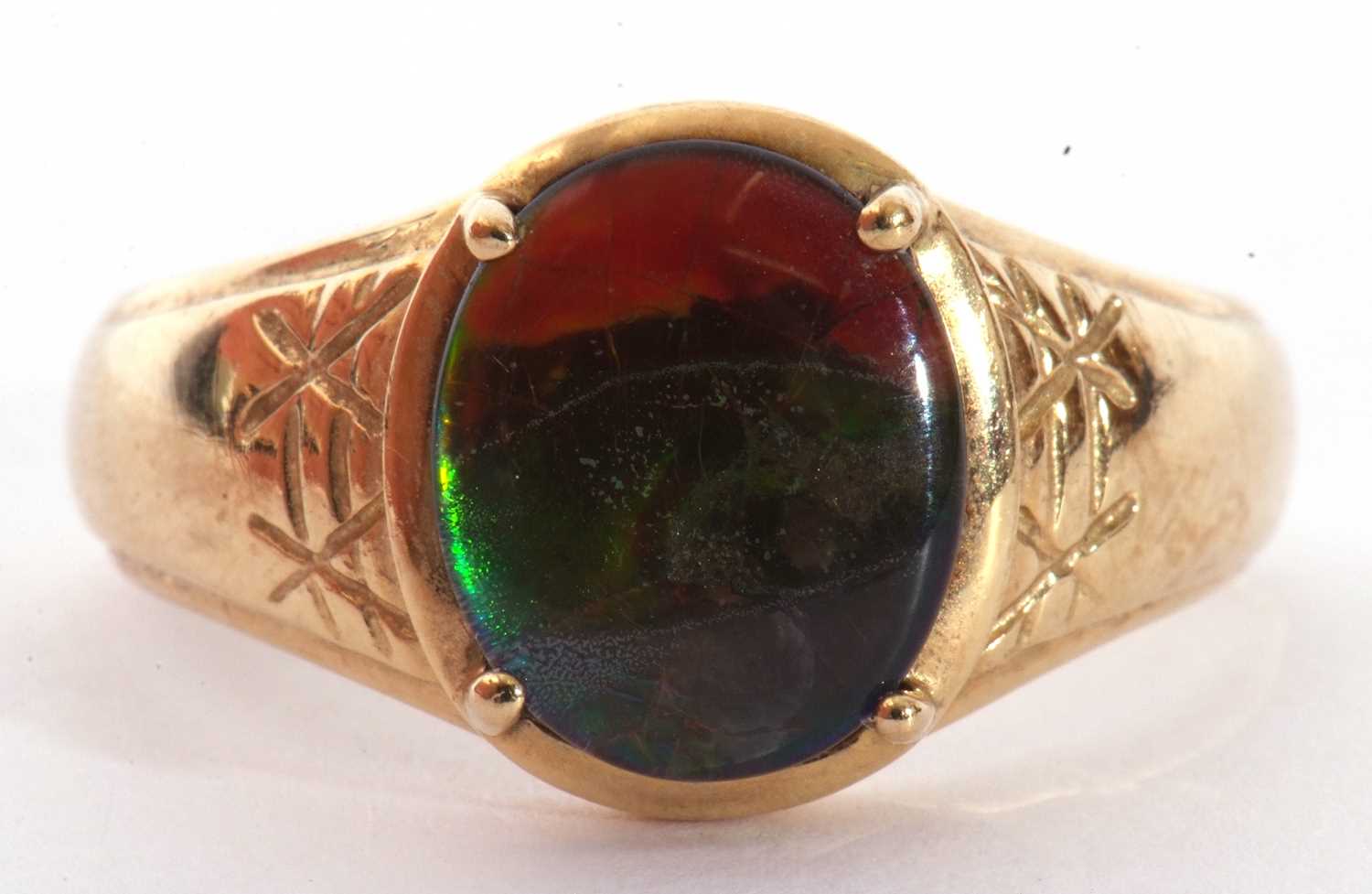Modern 9ct gold and iridescent stone ring, the oval cut iridescent stone four claw set between