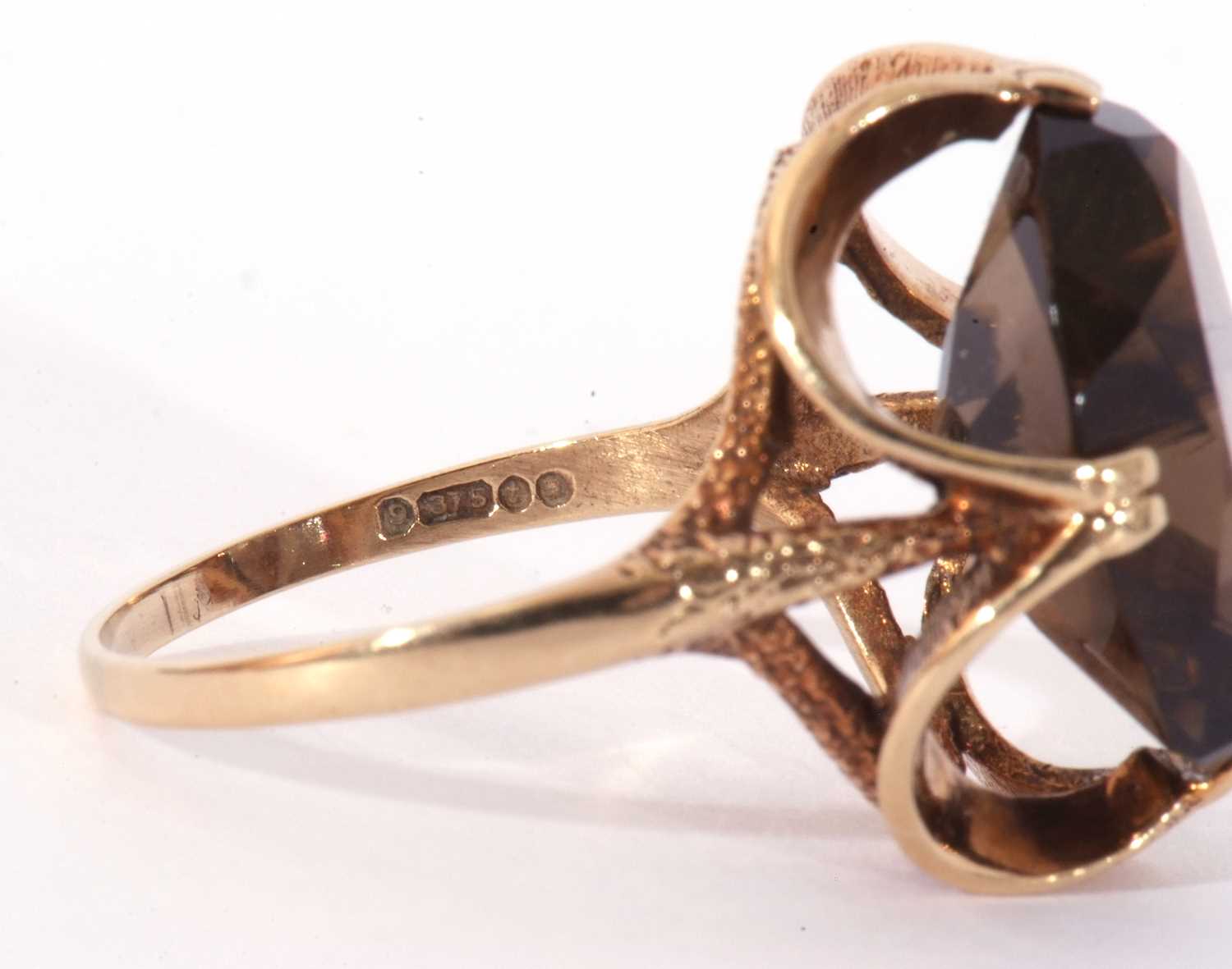 9ct gold smoky quartz dress ring, the large oval faceted quartz cardinal set in a stylised mount, - Image 6 of 9