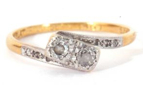 Antique diamond cross-over ring centring two small diamonds in illusion settings between diamond set