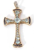 Modern 9k stamped cross pendant featuring 18 graduated light blue stones highlighted at each end