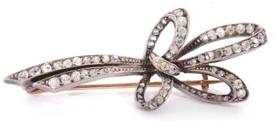 Antique diamond brooch, a tied ribbon design and set throughout with small graduated mixed old cut