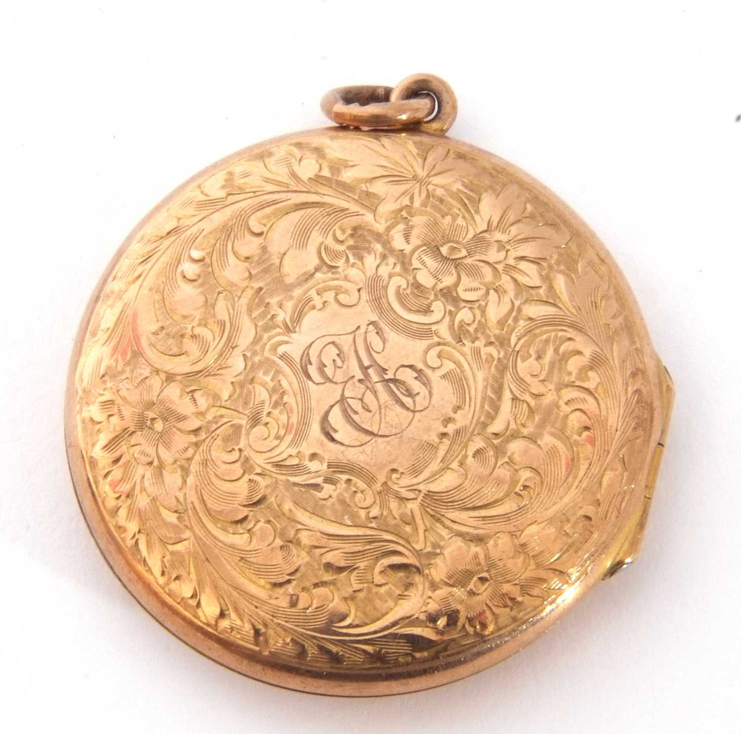 Hallmarked 9ct gold circular hinged locket, chased and engraved overall with scrolls etc, the