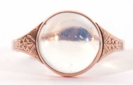 9ct stamped moonstone ring, the round cabochon moonstone bezel set between chased and engraved