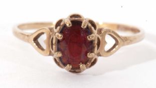 9ct gold garnet ring, multi-claw set and raised between open work heart shoulders, size N