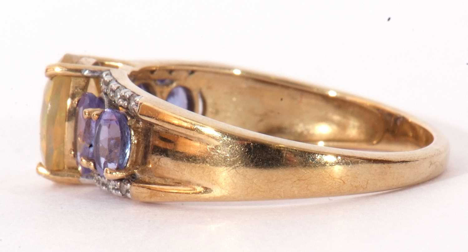 Modern 9ct gold, opal, tanzanite and diamond ring, the oval cut opal raised above a tanzanite and - Image 3 of 8