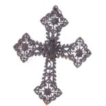 Ironwork cross pendant formed of lozenge shaped, filigree tracery at each end of the cross, a flower