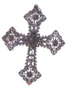 Ironwork cross pendant formed of lozenge shaped, filigree tracery at each end of the cross, a flower