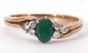 9ct gold green and white stone ring, the centre stone raised between two white stone set shoulders