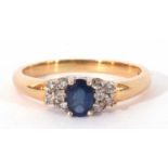 Sapphire and diamond ring centring an oval faceted sapphire, 6mm x 4mm, flanked by small diamond set
